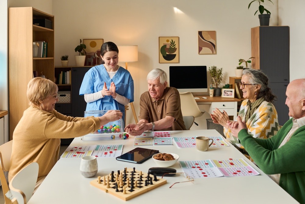 A group playing bingo together, applauding a win